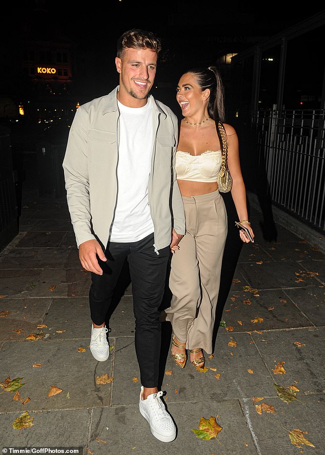 Beaming: The international dressage rider, 19, flashed her toned physique in a cream strapless crop top, teamed with a pair of beige trousers and gold heels