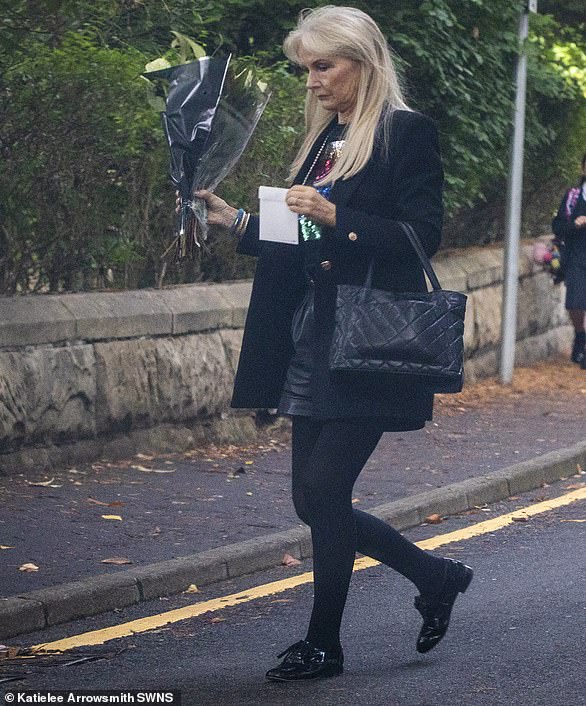 Anne Ferguson arrives to leave flowers at Darius's family home in Glasgow today