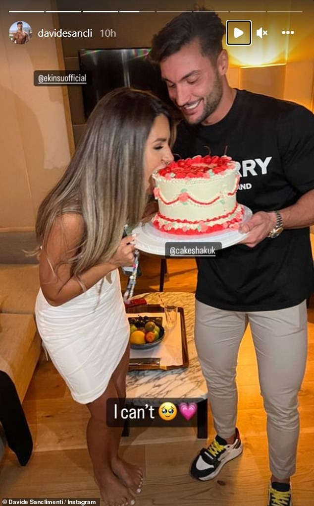 Yum! Davide beamed as he held a huge white and red frosted cake for Ekin-Su who took a huge bite out of it