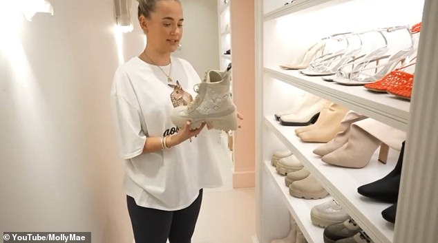 'I actually don't have that many heels': The former ITV2 beauty made her way day the corridor where her incredible shoe collection was put on display perfectly