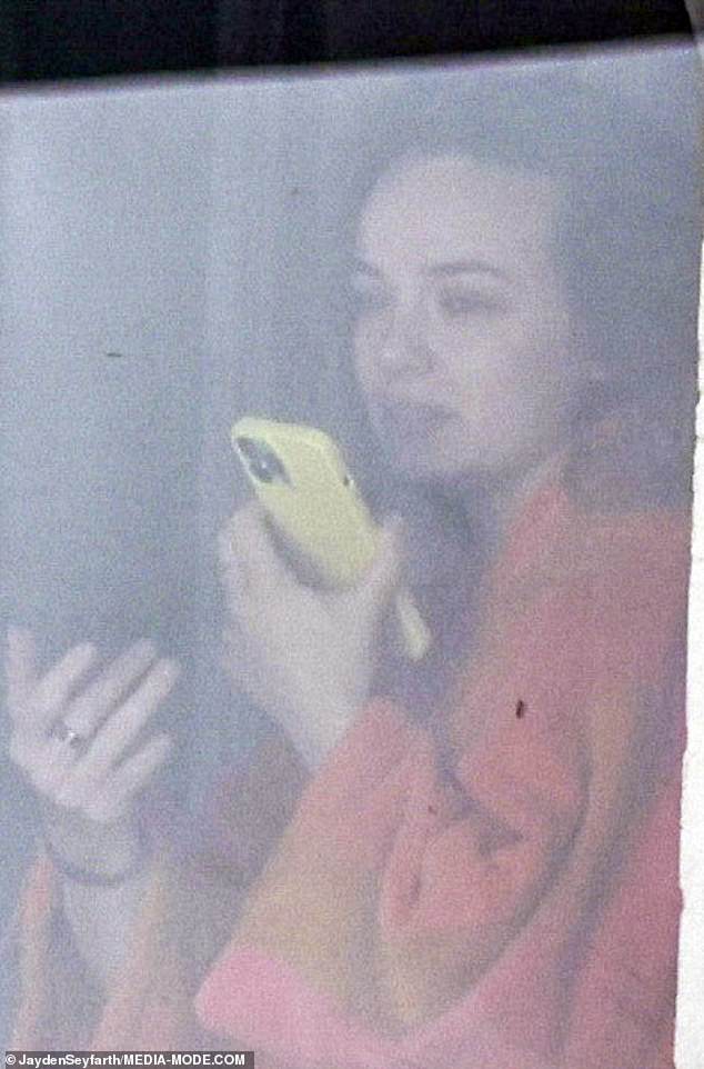 Dressed in an orange bathrobe and sporting wild hair, a makeup-free Abbie was seen speaking on her phone on loud speaker as she walked to her local café