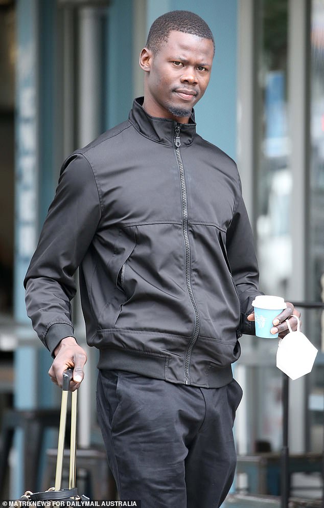 Anei Dut was ranked third on a list of 'South Sudan's 10 most handsome men alive' by a news website in 2021 but this year his most prominent appearances have been before a magistrate. He is pictured outside Sydney's Waverley Local Court on Thursday