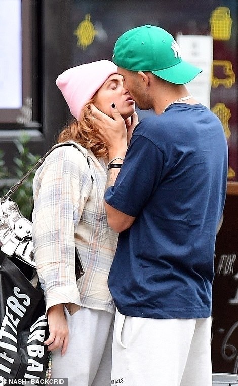 Looking alike: The celebrity couple dressed down in matching low-key looks, with Maisie sporting a pink beanie hat teamed with white sweatpants and a checked shacket