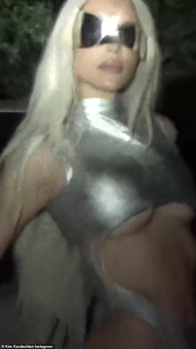 Fierce: After posing up a storm in front of a white car, she got behind the wheel and made unwavering eye contact with the camera as she listened to Beyoncé's hit track Alien Superstar