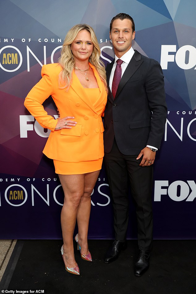 Miranda and Brendan: She posed with her husband Brendan McLoughlin, who opted for a classic black suit with a white dress shirt and purple tie