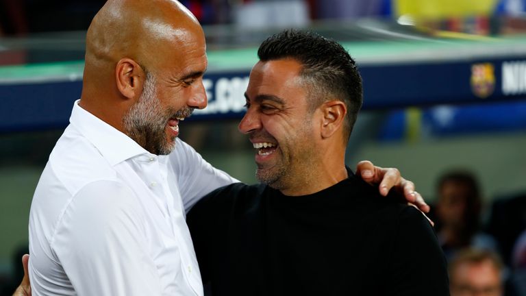 Barcelona&#39;s head coach Xavi Hernandez, right, greats Manchester City&#39;s head coach Pep Guardiola ahead of a charity friendly soccer match between Barcelona and Manchester City at the Camp Nou stadium in Barcelona, Spain, Wednesday, Aug. 24, 2022. (AP Photo/Joan Monfort)