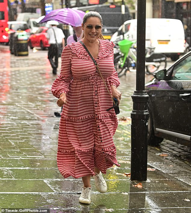 Natural beauty: Beneath the striking eye wear Kelly appeared to wear a simple palette of make-up as she ran to present her popular drive-time show