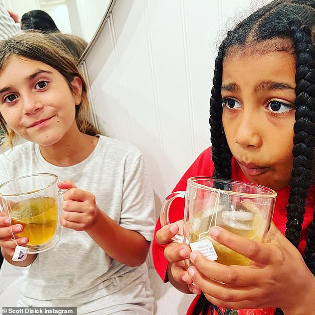 Family time: Kourtney's ex Scott Disick recently posted a heartwarming snap of their daughter Penelope, 10, enjoying a cup of tea with her cousin North West, nine