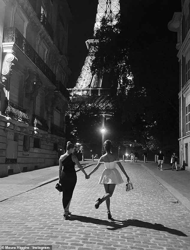 Girls night: The pals held hands as they meandered through the cobbled streets illuminated by the landmark's late night light show