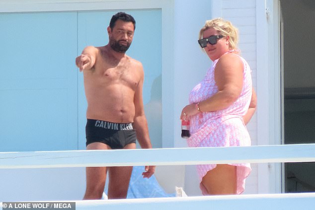 Mix and match: The former TOWIE star, 41, also wore a pink Dior one piece and a matching sarong while Rami wore Calvin Klein boxers