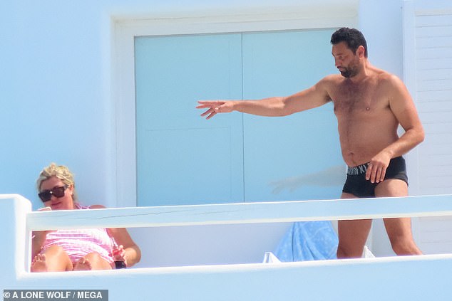 Toned: He went shirtless and showed off his toned physique while Gemma was glued to her phone