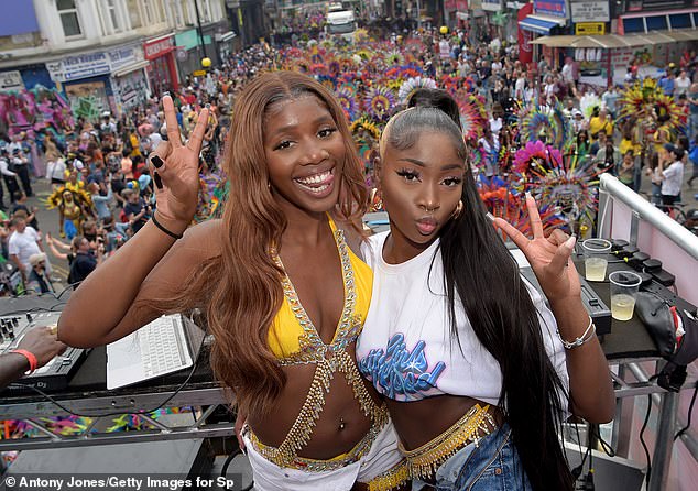 Party time: The pair were on board the Spotify x Socaholic float as crowds gathered at the event