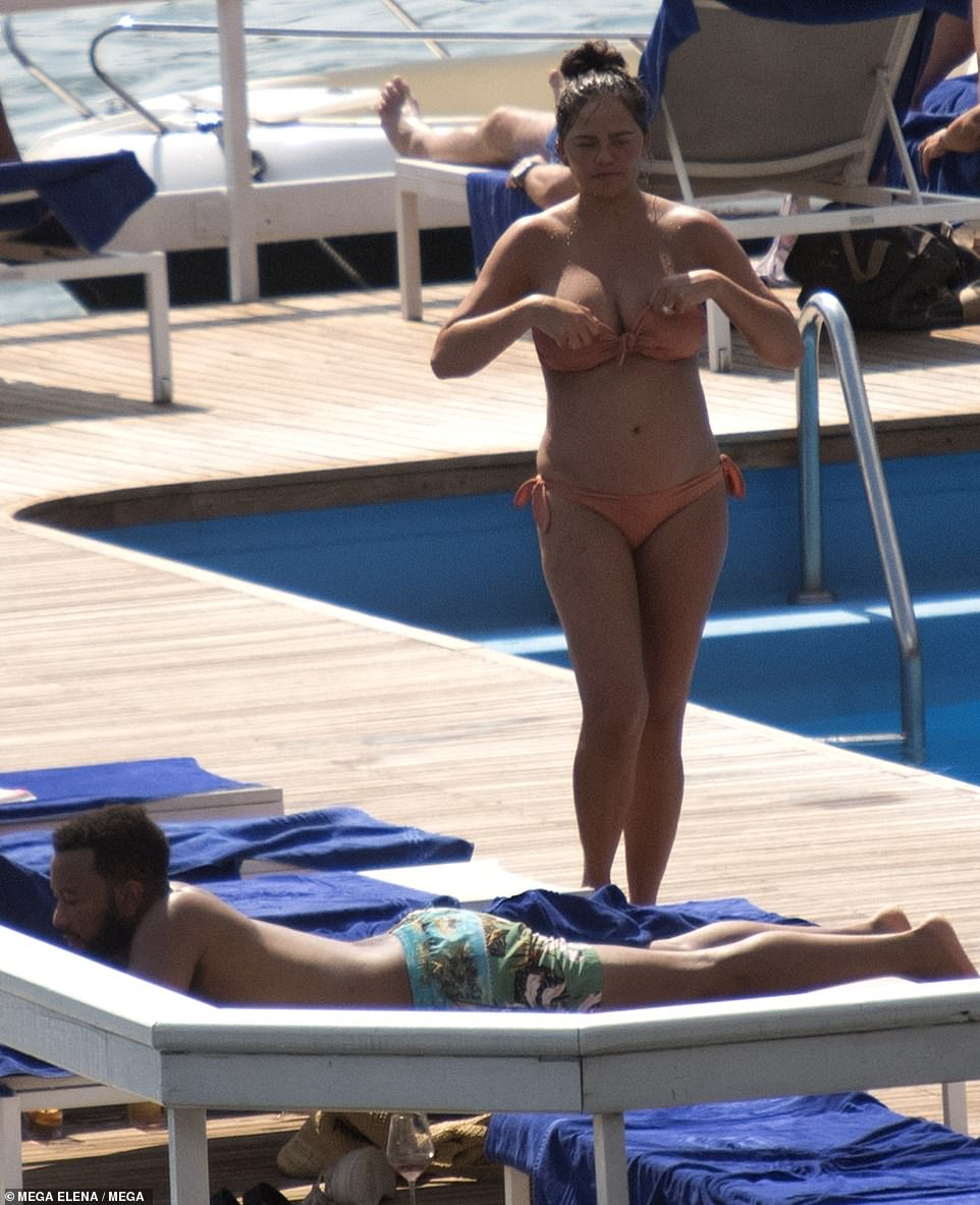 Soaked: Chrissy headed to air dry on the sun lounger, shaking off the pool-drops as she adjusted her bikini