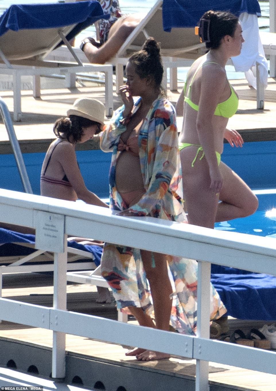 Beach coverup: And she later covered up with a colourful, longline mesh kimono over her swimwear