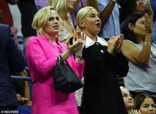 Rebel looked stylish in a figure-hugging bright pink dress and a matching jacket as she stood alongside her girlfriend Ramona