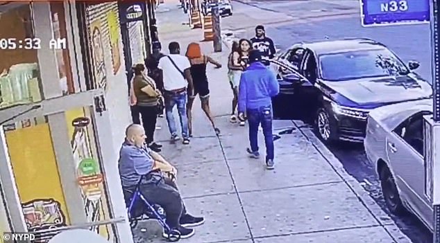 The 26-year-old woman in the red wig, center, followed the other woman out to her car where she punched her repeatedly