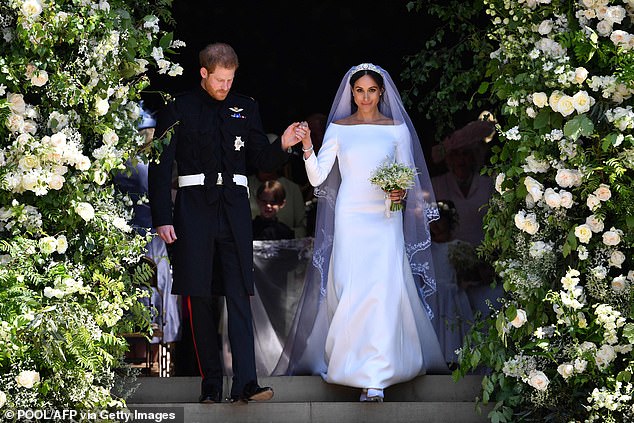 Meghan claimed she was told by a cast member of the Lion King in 2019 that South Africans had 'danced in the street' when she married Prince Harry - just like they did when 'Mandela was freed from prison'. (Harry and Meghan are pictured on their wedding day in May 2018)