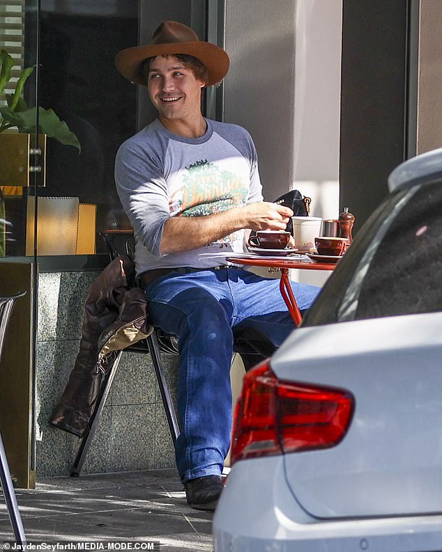 Logan, 32, chose a retro graphic T-shirt matched with a pair of loose dark blue jeans