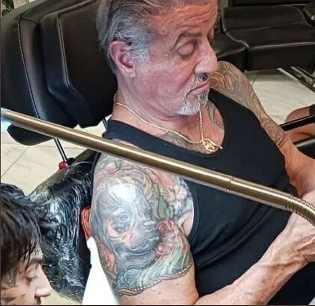 Tatt's telling: Flavin, 54, filed for divorce from Stallone after 25 years of marriage just days before DailyMail.com revealed that the actor had a giant tattoo of Flavin on his right bicep covered up with a picture of Butkus, Rocky's bull mastiff from the hit movies