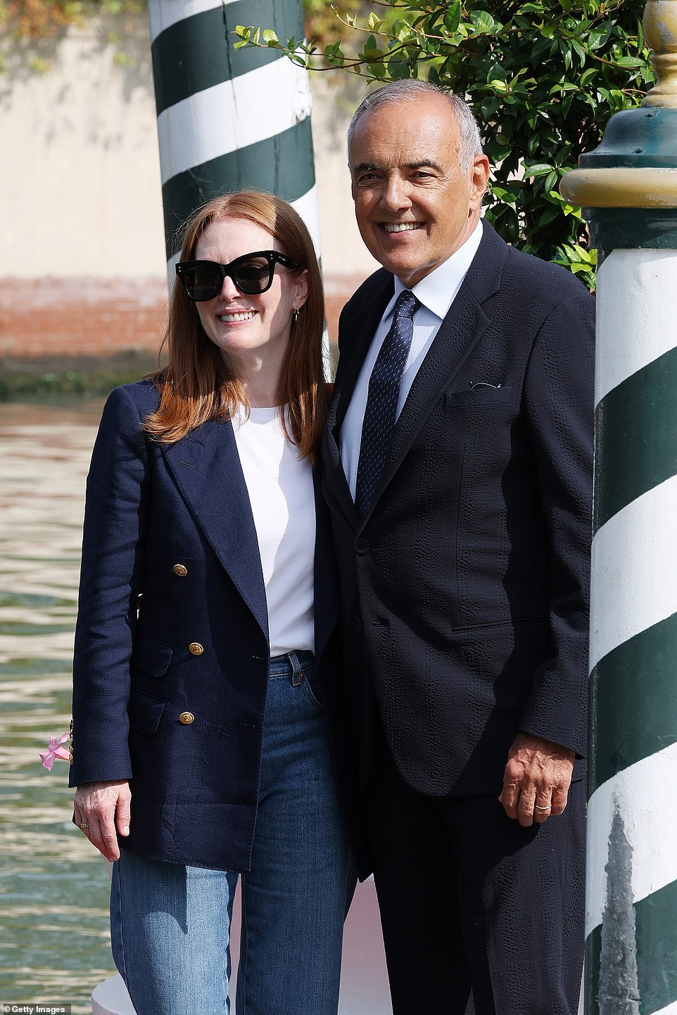 Beaming! The Oscar winner, who is the president of this year's jury, beamed as she stepped off a water taxi to be met by director of the festival Alberto Barbera (right)