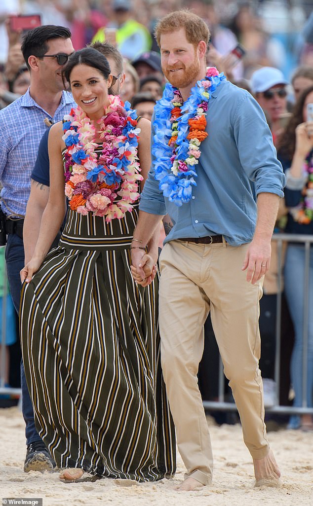 During the latest episode of her podcast, Meghan told Mariah she was only treated like a 'black woman' for the first time when she began dating Prince Harry (pictured in Sydney in 2018)