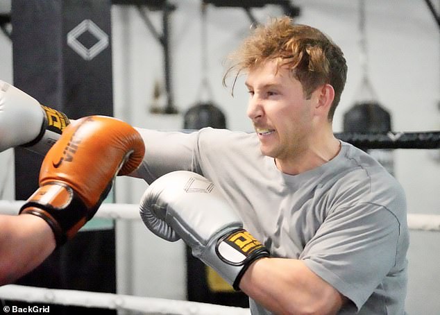 Mouth guard gritted between his teeth, he then squared off with a smaller, topless opponent, taking as good as he gave in both fights