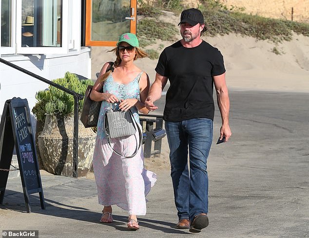 Cute couple: The 51-year-old reality television personality and her husband, 49, stayed close as they took a short stroll and joined each other for a lunch date while enjoying the summertime weather