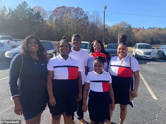 Tate (pictured right second row), a single mother of nine children is picture here with some of her children. Her youngest child is four years old