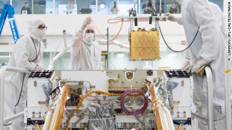 Members of NASA&#39;s Mars 2020 project install the Mars Oxygen In-Situ Resource Utilization Experiment (MOXIE) into the chassis of the Perseverance rover. 