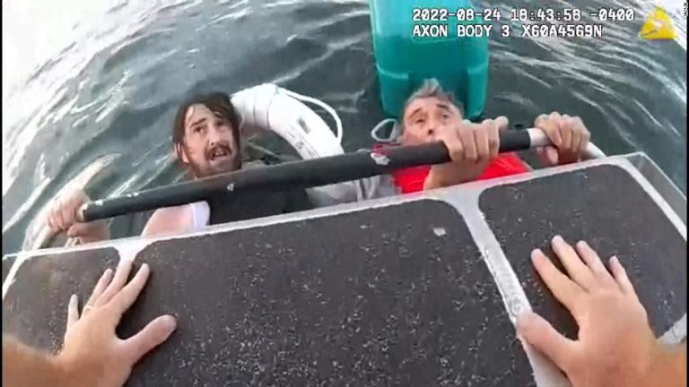 'I can't hold on much longer': Father and son rescued after boat sinks