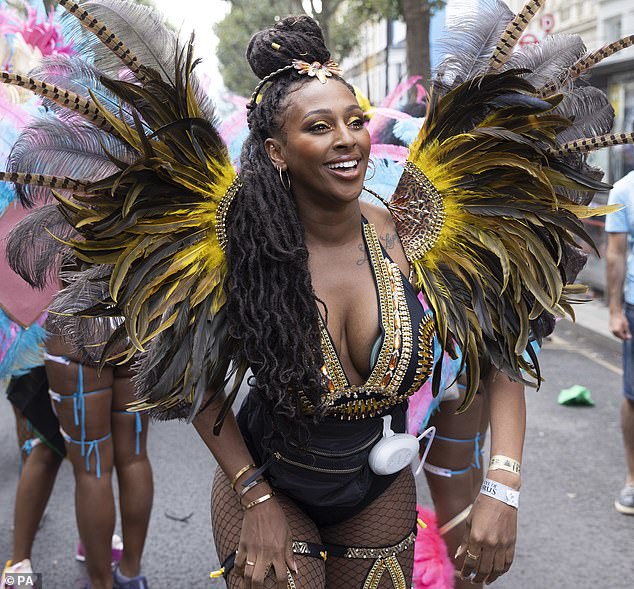 Alexandra Burke wears a breast pump beneath her plunging costume at Notting Hill Carnival