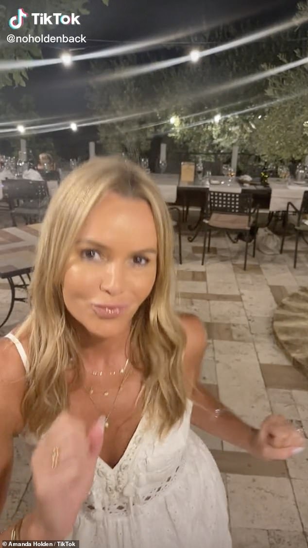 Amanda Holden enjoys a boogie with her lookalike daughters Lexi and Hollie, 10, in Sicily