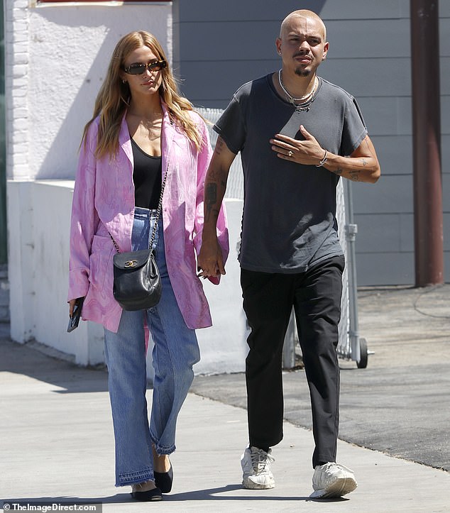 Ashlee Simpson holds hands with her husband Evan Ross as they take a stroll in Los Angeles