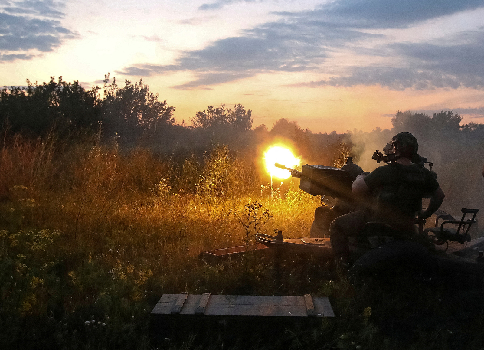 A Ukrainian serviceman fires an anti-aircraft cannon at a position near a front line in the Ukraine's Kharkiv region, on Aug. 10. 