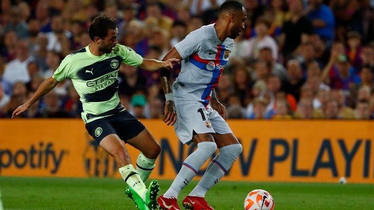 Barcelona&#39;s Pierre-Emerick Aubameyang, right, is challenged by Manchester City&#39;s Bernardo Silva during a charity friendly soccer match between Barcelona and Manchester City at the Camp Nou stadium in Barcelona, Spain, Wednesday, Aug. 24, 2022. (AP Photo/Joan Monfort)