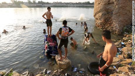 People cool off at the Tigris River during hot weather in Baghdad, Iraq on August 4.