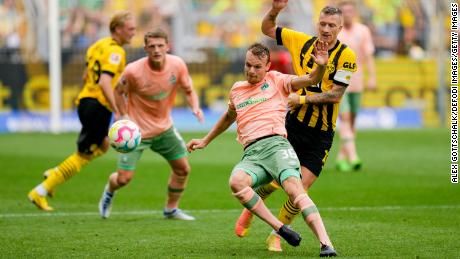 Christian Gross of Werder Bremen and Borussia Dortmund&#39;s Marco Reus in action during their Bundesliga match. 