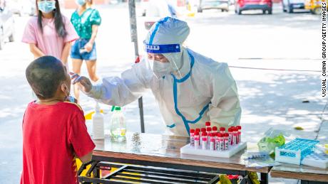 A medical worker conducts Covid testing for a child on August 7 in Sanya.