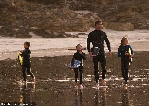 Chris Hemsworth spends the evening surfing with his kids in Byron Bay 