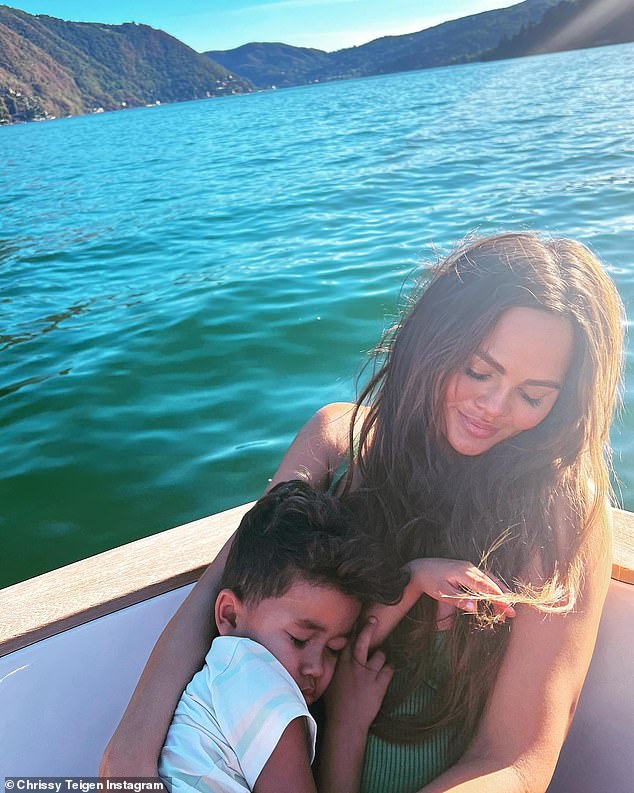 Chrissy Teigen relaxes with ‘sleep king’ son Miles, four, on a boat as family enjoys summer getaway