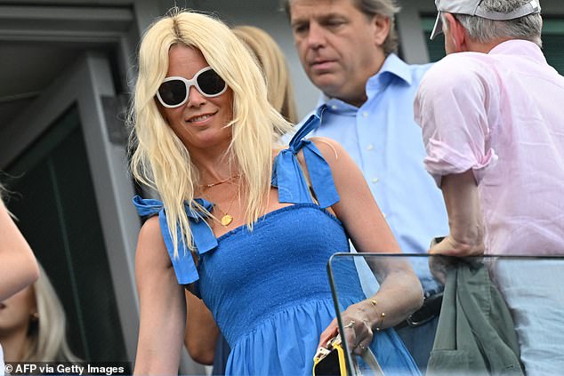 Claudia Schiffer looks chic in an eye-catching blue dress at Stamford Bridge stadium