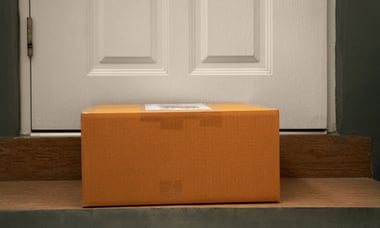 A cardboard box at a front door