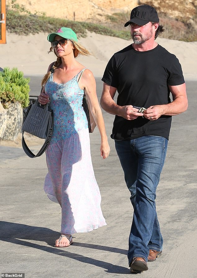 Denise Richards and Aaron Phypers stay close while stepping out on a lunch date in Malibu