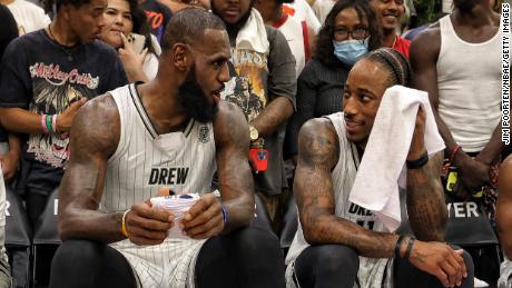 James chats to DeMar DeRozan during a game in the Drew League. 