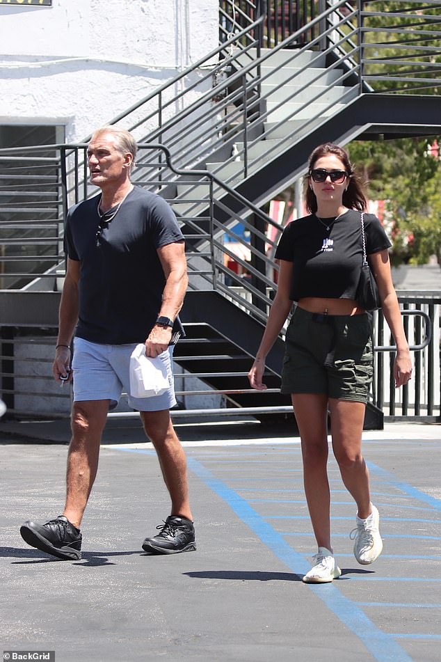 Dolph Lundgren cuts a casual figure in black T-shirt and white shorts with fiancée Emma Krokdal