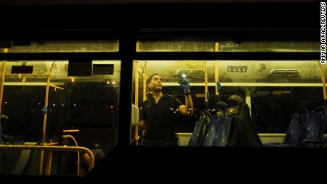 An Israeli police officer checks a bus following a shooting incident in Jerusalem early Sunday morning.