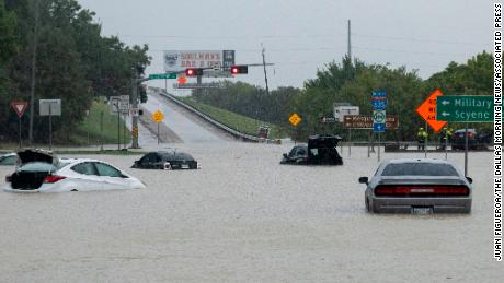 Stalled cars sit abandoned on the flooded Interstate 635 Service Road in Mesquite, Texas, on Monday.