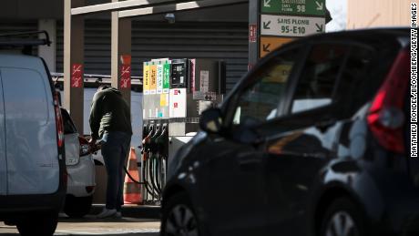 A customer refuels a vehicle at a TotalEnergies SE gas station in Toulouse, France, on Thursday, Feb. 10, 2022. TotalEnergies promised to increase its dividend and buy back more shares after posting a record fourth-quarter profit. 