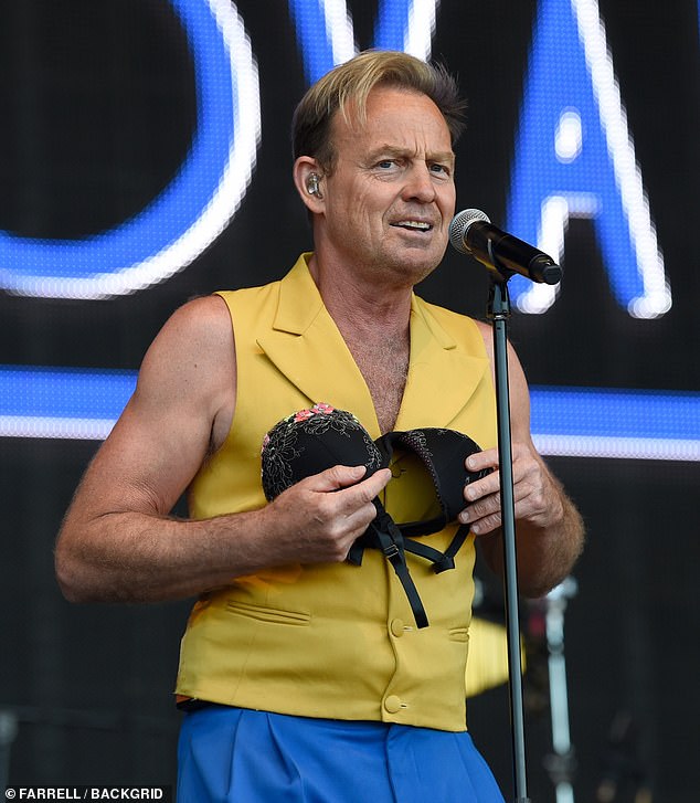 Jason Donovan looks puzzled after fan throws bra at him during Rewind North performance