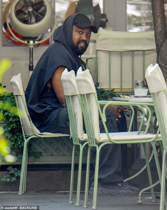 Kanye West has breakfast with a friend at the upscale French bakery Ladurée in New York City